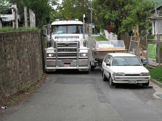 NOISY BATTLE: Residents have parked a boat and trailer on a narrow Lutwyche street to discourage Airport Link and Northern Busway excavators from driving trucks through.