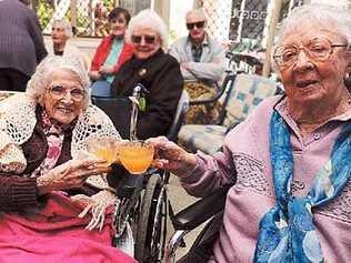 Maranoa Alstonville residents Grace Hunter (left) and Edith Paff toast each on their 100th birthdays.