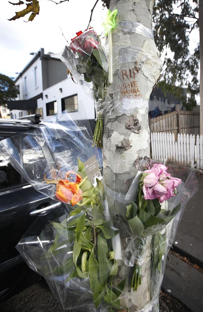 Flower tributes left for a girl found dead at the end of William St in Abbotsford. Picture: David Caird