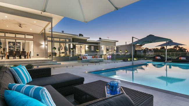 The interiors open easily to an inviting pool and outdoor entertainment area.