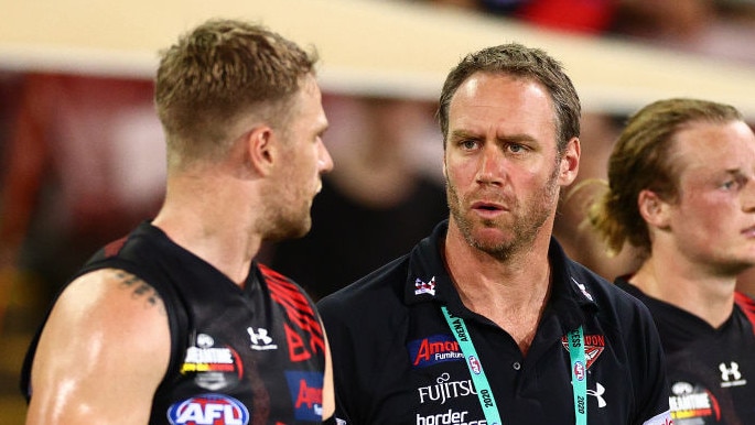 DARWIN, AUSTRALIA - AUGUST 22: Bombers assistant coach Ben Rutten speaks to Jake Stringer at the break during the round 13 AFL match between the Essendon Bombers and the Richmond Tigers at TIO Stadium on August 22, 2020 in Darwin, Australia. (Photo by Daniel Kalisz/Getty Images)