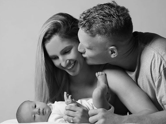 Kim with partner Adam Treloar and their daughter Georgie when she was a newborn. Picture: Instagram