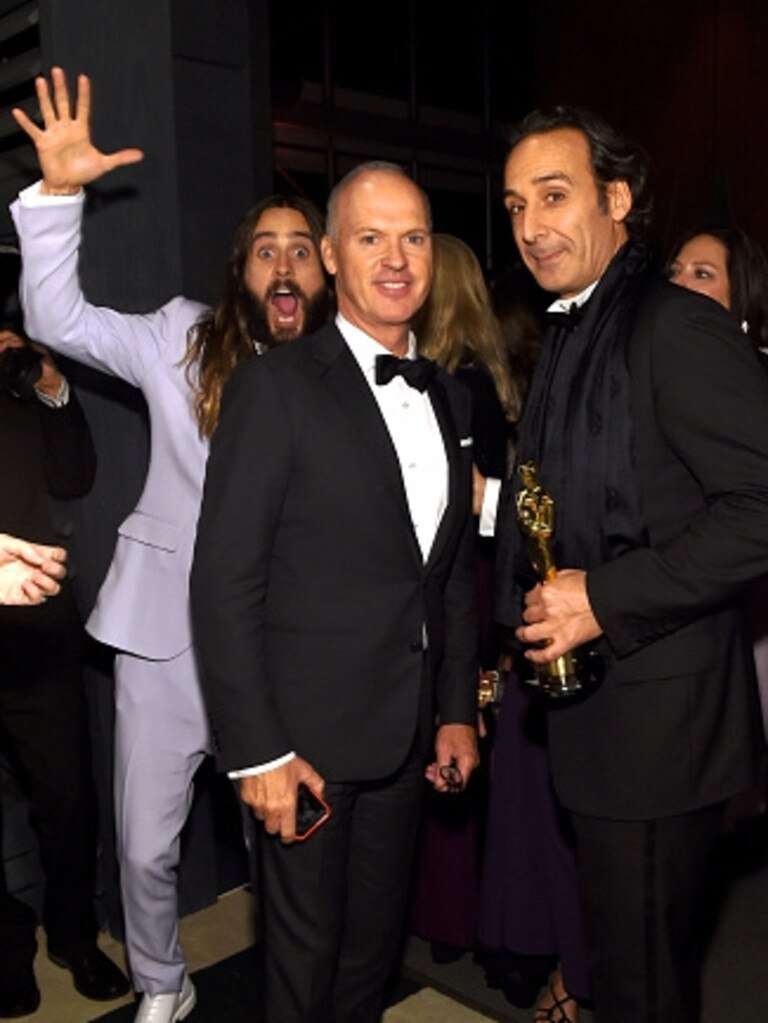 Jared Leto photobombs Michael Keaton and Alexandre Desplat at the 2015 Vanity Fair Oscar Party on February 22, 2015 in Beverly Hills. Picture: Getty