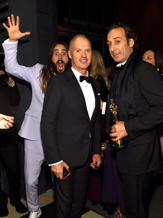 Jared Leto photobombs Michael Keaton and Alexandre Desplat at the 2015 Vanity Fair Oscar Party on February 22, 2015 in Beverly Hills. Picture: Getty