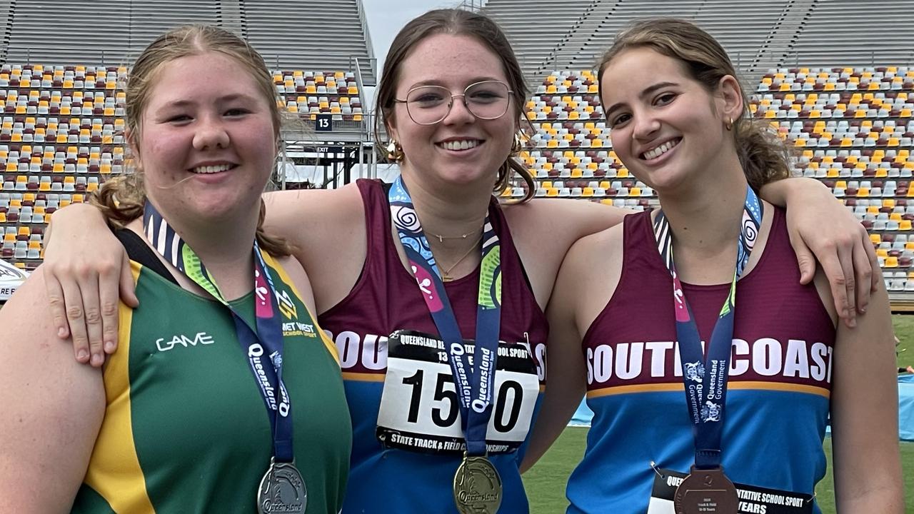 Gabi Cannen, left, with Mackenzie Crowley, gold, and Sophie Sears after the hammer throw.