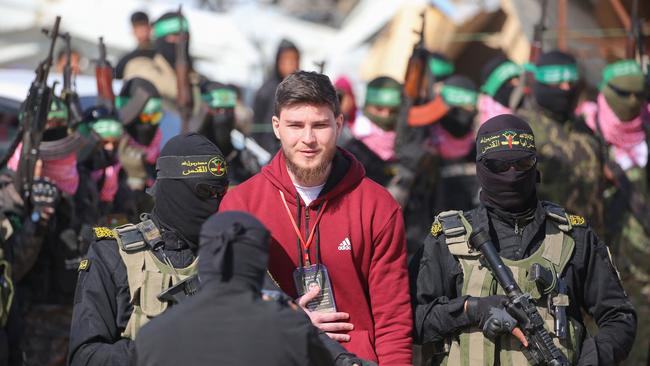 Islamic Jihad fighters escort Israeli-Russian Sasha Trupanov before handing him over to a Red Cross team in Khan Younis in the swap between Hamas and Israel. Picture: AFP