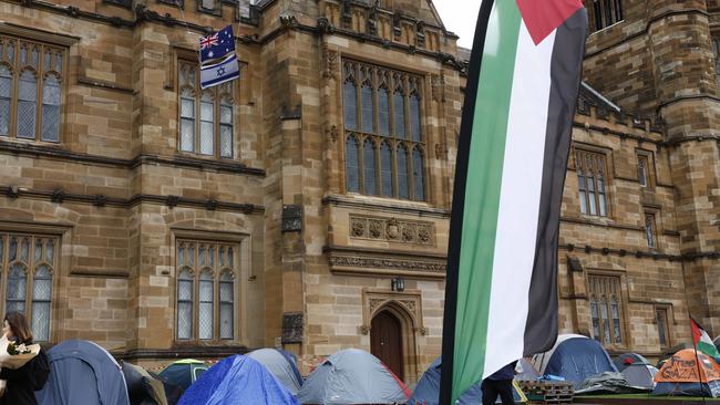 A lone Israeli flag twinned with an Australian flag, above the tent set up at the pro-Palestine encampment at Sydney University, in May 2024. Picture: Richard Dobson