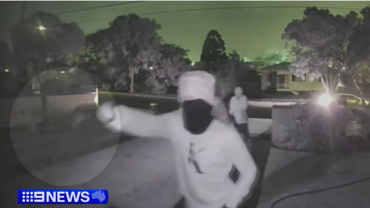 One brandishes a knife during the alleged attempted break-in. Picture: 9News