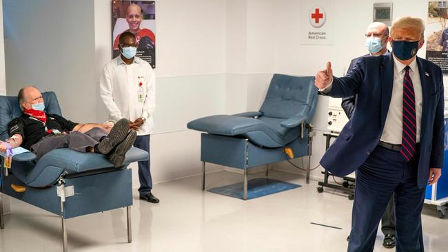 Donald Trump looks on as patients donate plasma at the American Red Cross National Headquarters in Washington. Picture: AFP.