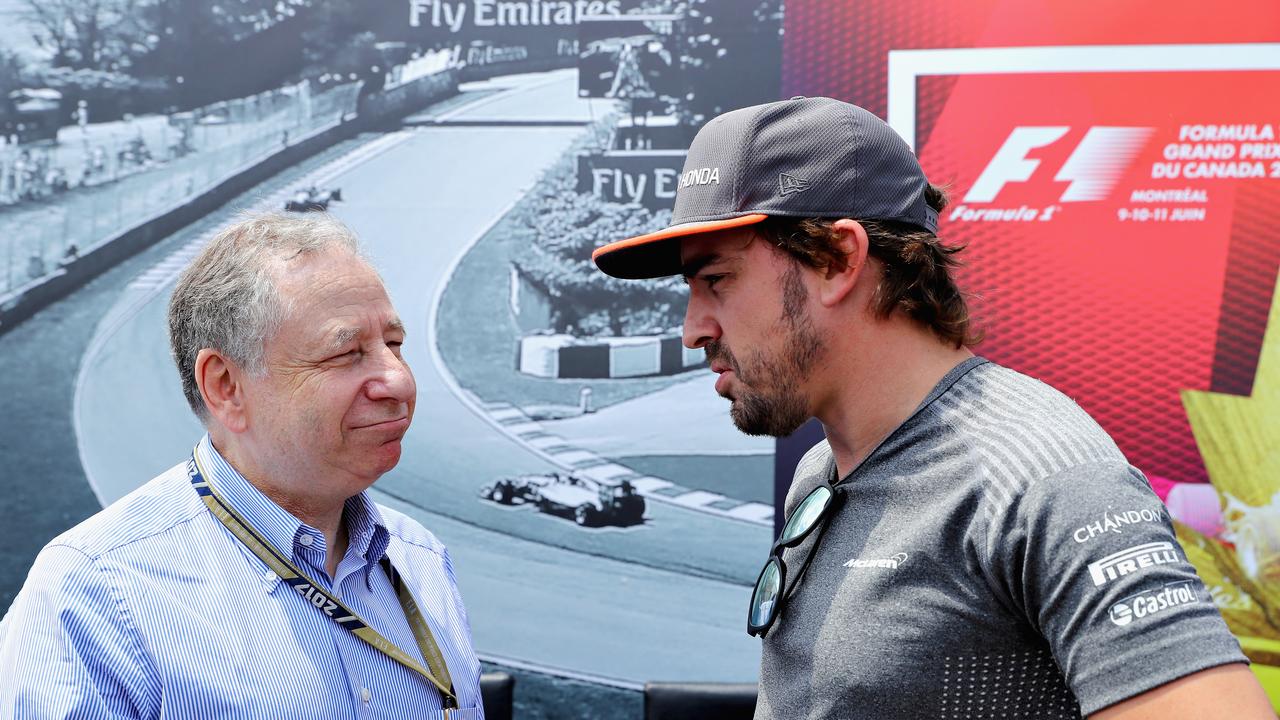 Jean Todt talking to Fernando Alonso. (Photo by Clive Mason/Getty Images)