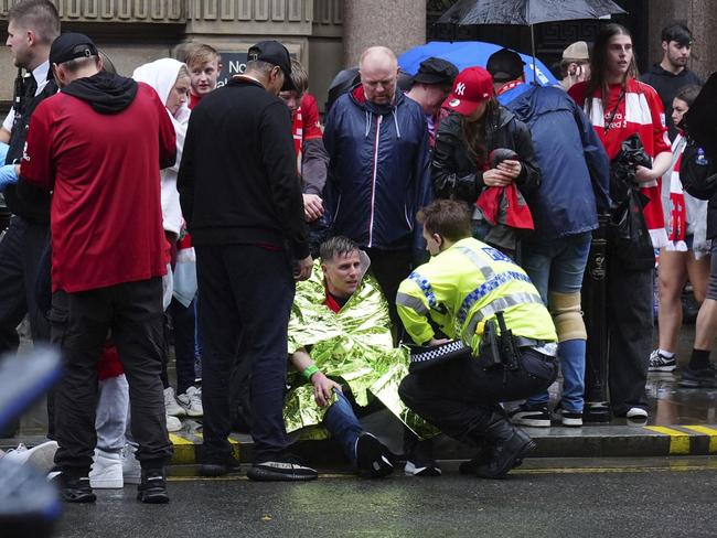 A police officer speaks with a man at the site of an incident on Water Street near the Liver Building in Liverpool. Picture: Owen Humphreys/PA via AP