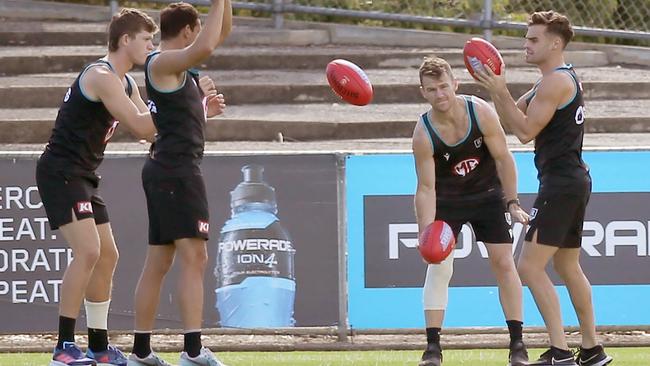 Mitch Georgiades, left, and Robbie Gray, second from right, both wearing leg strapping after the Power’s Round 7 win. Picture: Dean Martin