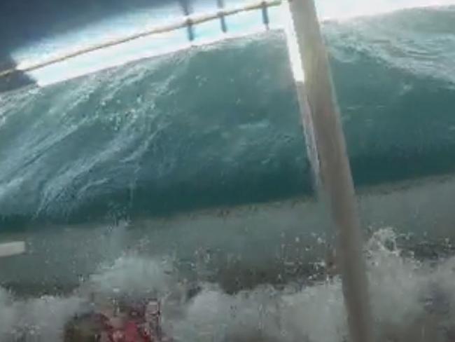 Tourists scream as they are engulfed by waves in the chilling footage.