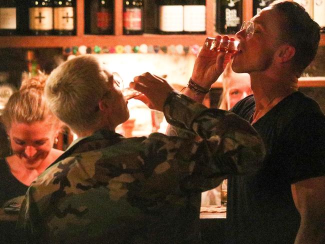 Bottoms up ... Bieber and his mate Carl Lentz down a shot at the Blue Door Bar in Queenstown, New Zealand. Picture: AKM-GSI/BackGrid