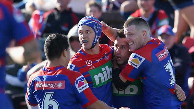 NEWCASTLE, AUSTRALIA - AUGUST 17: Mitchell Pearce of the Newcastle Knights celebrates his try with team mates during the round 22 NRL match between the Newcastle Knights and the North Queensland Cowboys at McDonald Jones Stadium on August 17, 2019 in Newcastle, Australia. (Photo by Ashley Feder/Getty Images)