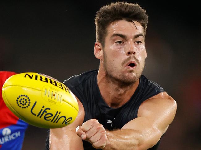 MELBOURNE, AUSTRALIA - MARCH 03: George Hewett of the Blues is chased by Tom McDonald of the Demons during the 2022 AFL Community Series match between the Carlton Blues and the Melbourne Demons at Marvel Stadium on March 3, 2022 In Melbourne, Australia. (Photo by Michael Willson/AFL Photos via Getty Images)