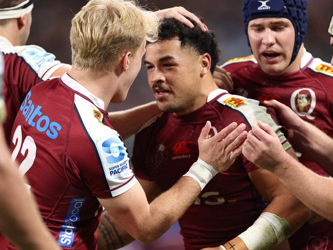 Redsâ Hunter Paisami (C) celebrates with teammates after scoring a try during the Super Rugby match between the New South Wales Waratahs and Queensland Reds at the Allianz Stadium in Sydney on May 31, 2024. (Photo by DAVID GRAY / AFP) / -- IMAGE RESTRICTED TO EDITORIAL USE - STRICTLY NO COMMERCIAL USE --