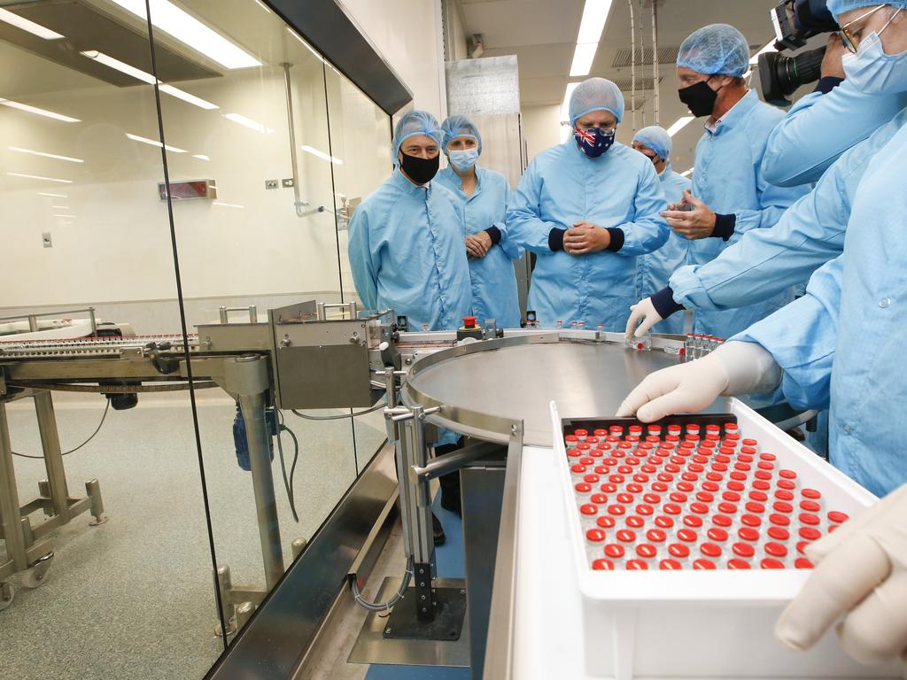 Prime Minister Scott Morrison inspects freshly produced vaccine vials. Picture: David Caird