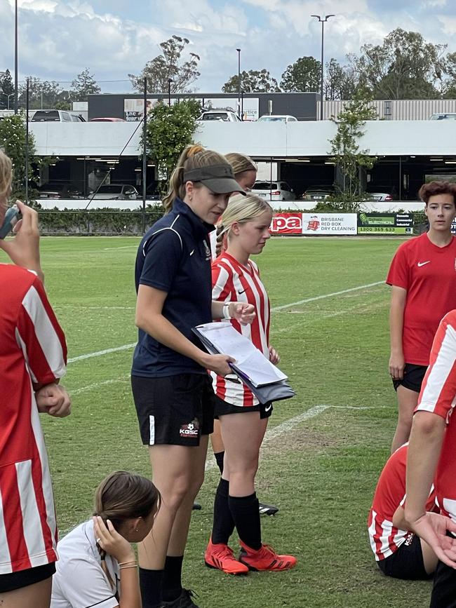 The Kelvin Grove SC junior girls coach addresses her side.