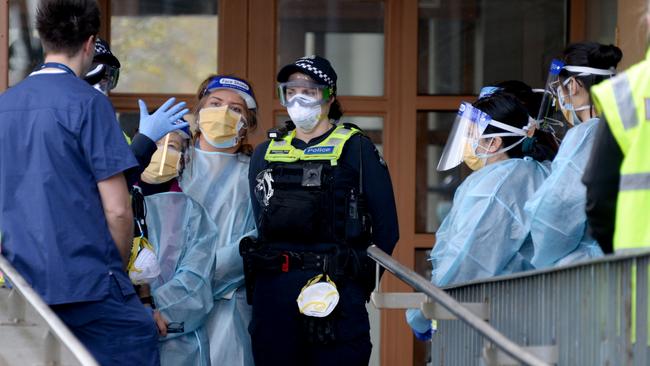 Police and health workers at the Flemington public housing estate after it was put into lockdown on Saturday. Picture: NCA NewsWire/Andrew Henshaw