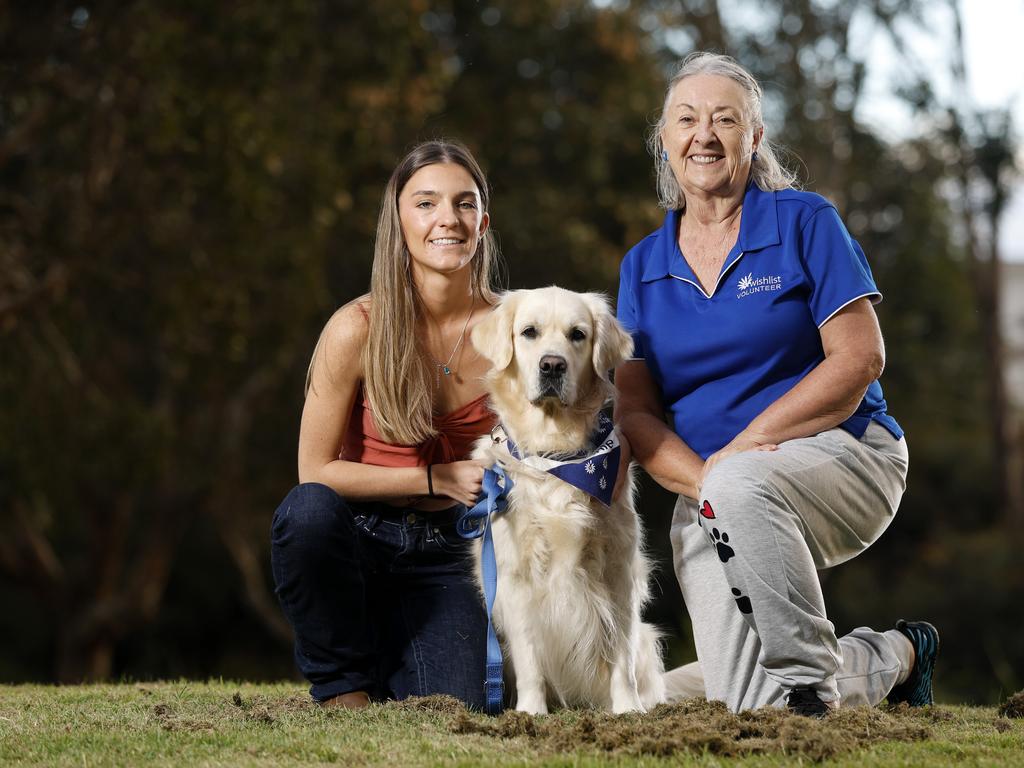 Summer Stevenson with Bonnie and Jane Remington-Gurney, Wishlist therapy dog handler. Picture: Josh Woning