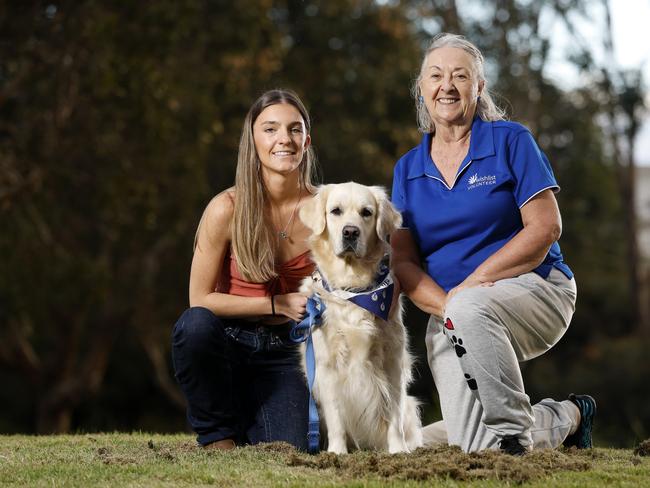 Summer Stevenson with Bonnie and Jane Remington-Gurney, Wishlist therapy dog handler. Picture: Josh Woning