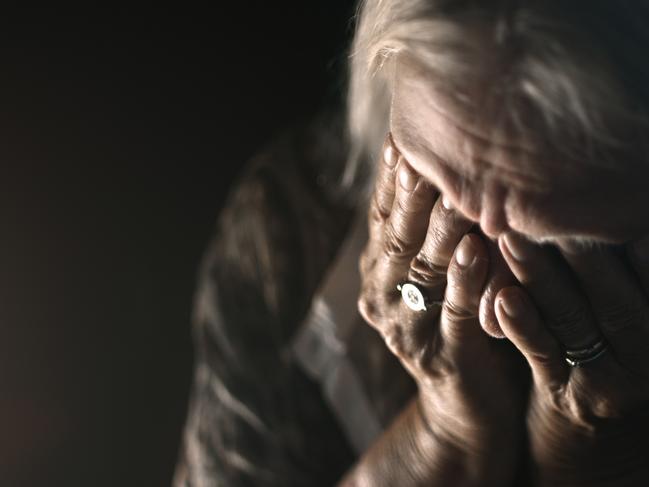 ISTOCK GENERIC -  Desperate senior crying in a dark room. Perfectly usable for a wide range of topics like depression, loneliness or mental health in general.