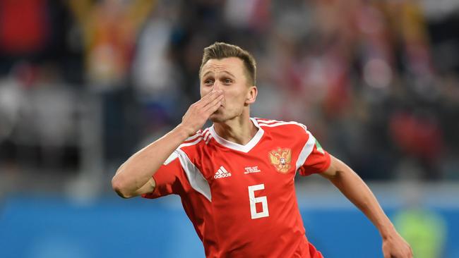 CORRECTION - Russia's midfielder Denis Cheryshev celebrates scoring the 2-0 goal during the Russia 2018 World Cup Group A football match between Russia and Egypt at the Saint Petersburg Stadium in Saint Petersburg on June 19, 2018.  / AFP PHOTO / GABRIEL BOUYS / RESTRICTED TO EDITORIAL USE - NO MOBILE PUSH ALERTS/DOWNLOADS / “The erroneous mention[s] appearing in the metadata of this photo by GABRIEL BOUYS                      has been modified in AFP systems in the following manner: [Russia's midfielder Denis Cheryshev] instead of [ Egypt's defender Ahmed Hegazi]. Please immediately remove the erroneous mention[s] from all your online services and delete it (them) from your servers. If you have been authorized by AFP to distribute it (them) to third parties, please ensure that the same actions are carried out by them. Failure to promptly comply with these instructions will entail liability on your part for any continued or post notification usage. Therefore we thank you very much for all your attention and prompt action. We are sorry for the inconvenience this notification may cause and remain at your disposal for any further information you may require.”