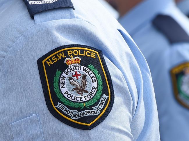 Stock image of New South Wales Police badges in Sydney, Friday, Aug. 16, 2013.  (AAP Image/Dean Lewins) NO ARCHIVING