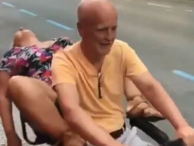 Onlookers can be heard laughing as the woman, who appears to be intoxicated, is driven past.