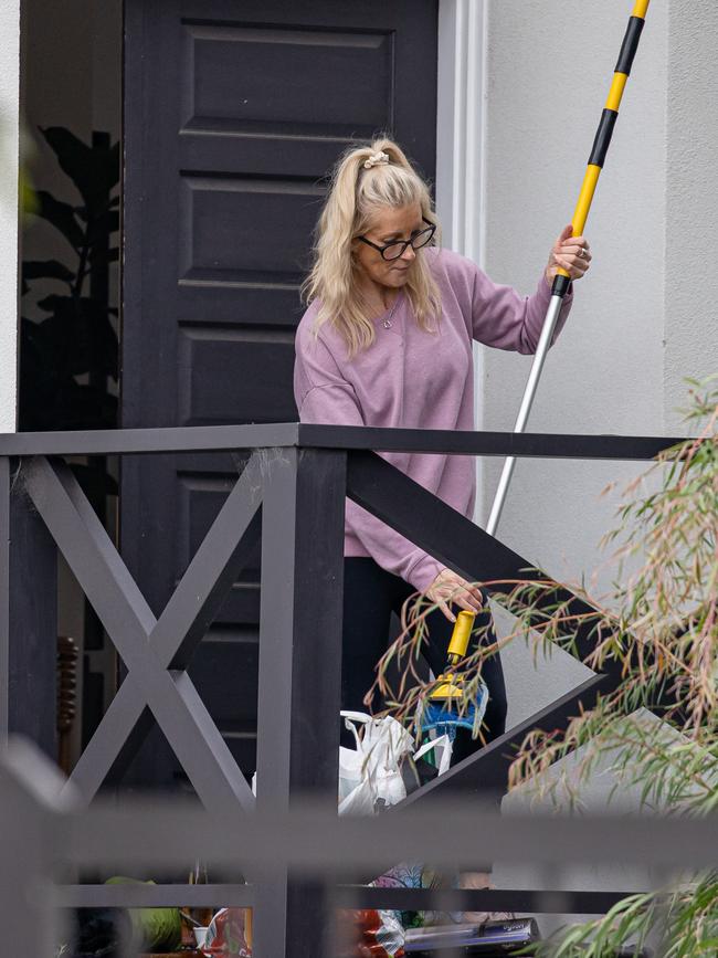 Cleaners attend the Airbnb property where five jockeys were busted having an illegal party.