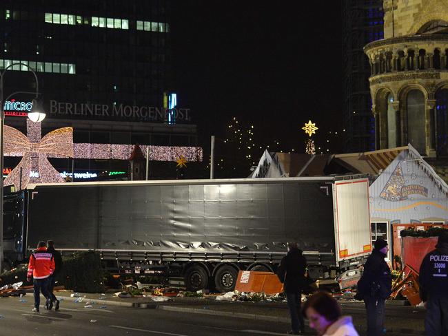 Policemen stand next to a truck that crashed into a Christmas market in Berlin. Picture: AFP