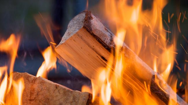 Burning firewood at campfire