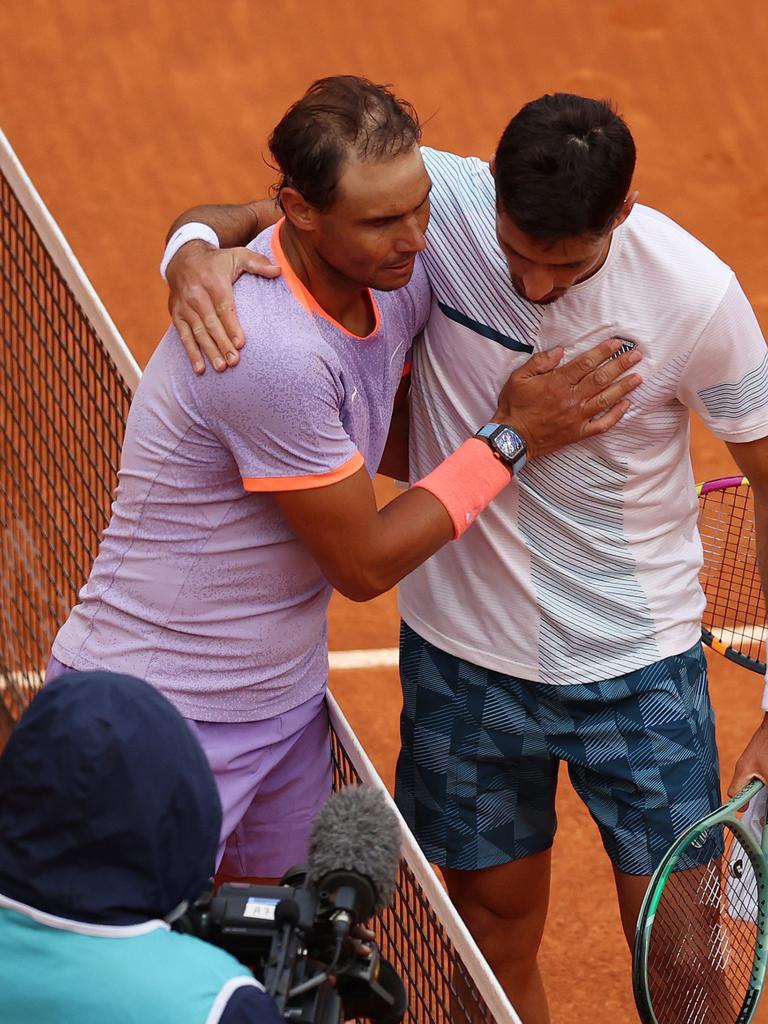 Rafael Nadal and Pedro Cachin hug it out. Photo by Clive Brunskill/Getty Images.