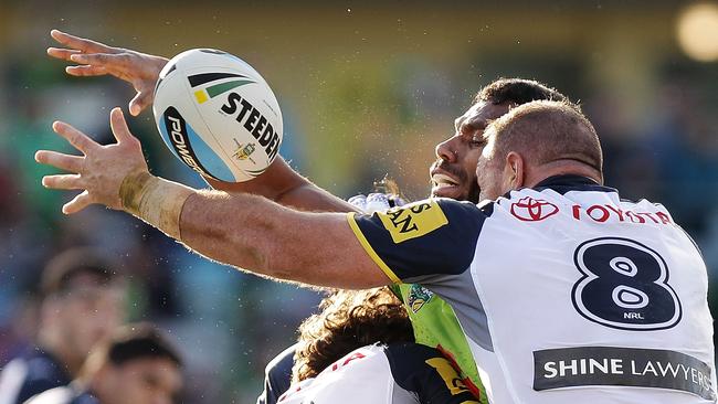 Sisa Waqa of the Raiders and Matt Scott of the Cowboys contest possession in round 15.