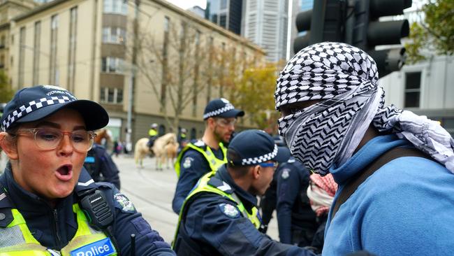 Pro-Palestinian protesters face off with police outside the Victorian parliament. Picture: NCA NewsWire / Luis Enrique Ascui