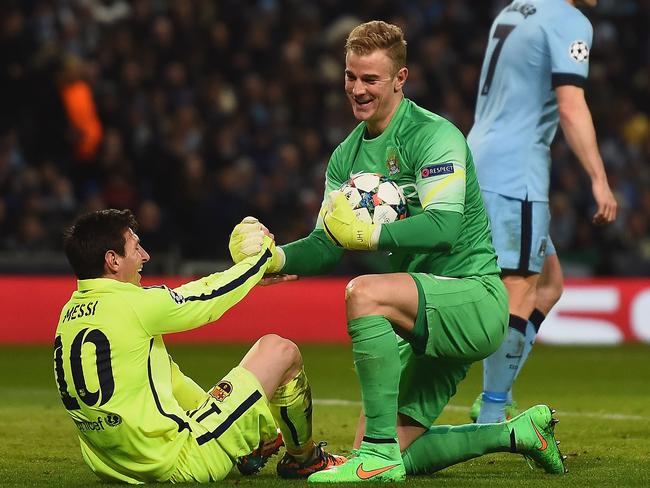 Joe Hart of Manchester City helps Lionel Messi of Barcelona in 2015.