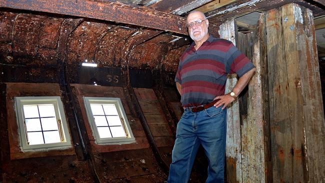 City of Adelaide project director Peter Christopher in the ship's stern with new curved windows especially made to fit. Picture: Bernard Humphreys