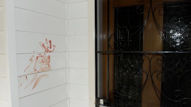 Bloodied handprints near the front door of an Airbnb home. Picture: Andrew Henshaw