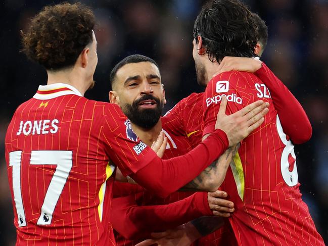 MANCHESTER, ENGLAND - FEBRUARY 23: Dominik Szoboszlai of Liverpool celebrates scoring his team's second goal with teammates Curtis Jones and Mohamed Salah during the Premier League match between Manchester City FC and Liverpool FC at Etihad Stadium on February 23, 2025 in Manchester, England. (Photo by Alex Pantling/Getty Images)