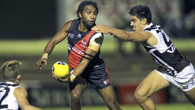 Gibson Turner of West Adelaide gets a handball away under pressure. Picture: Dean Martin