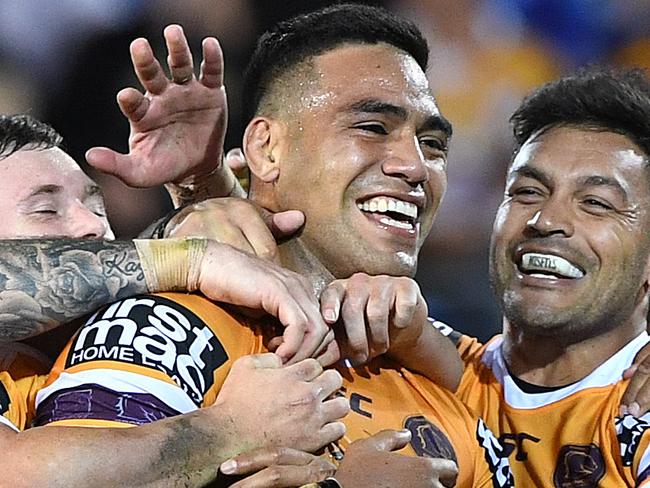 Joe Ofahengaue of the Broncos (centre) celebrates after scoring a try during the Round 17 NRL match between the Gold Coast Titans and the Brisbane Broncos at Cbus Super Stadium in Robina on the Gold Coast. Sunday, July 8, 2018. (AAP Image/Dave Hunt) NO ARCHIVING, EDITORIAL USE ONLY