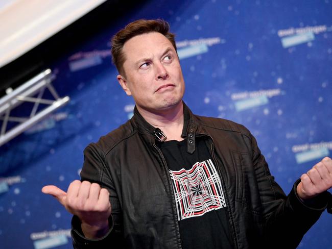 (FILES) In this file photo taken on December 01, 2020 SpaceX owner and Tesla CEO Elon Musk (R) gestures as he arrives on the red carpet for the Axel Springer Awards ceremony, in Berlin. - Tesla boss Elon Musk strongly denied March 20, 2021 that his cars, which gather large amounts of data, could ever be used to spy on China despite fears raised by Beijing, the Wall Street Journal reported. (Photo by Britta Pedersen / POOL / AFP)