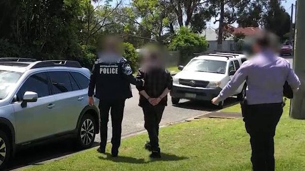 Tyson Murray being arrested by Australian Federal Police officers. Credit: AFP