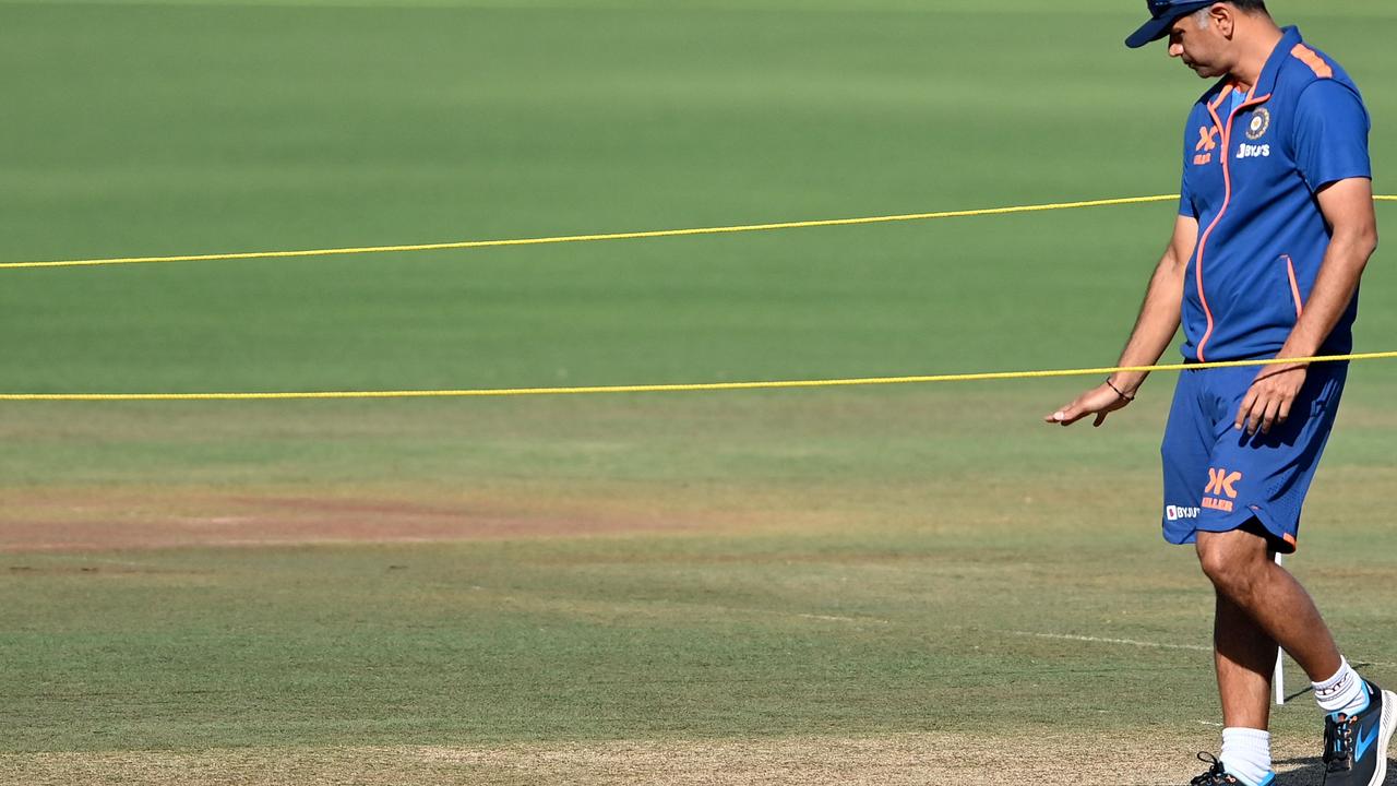 India's coach Rahul Dravid inspects the pitch.