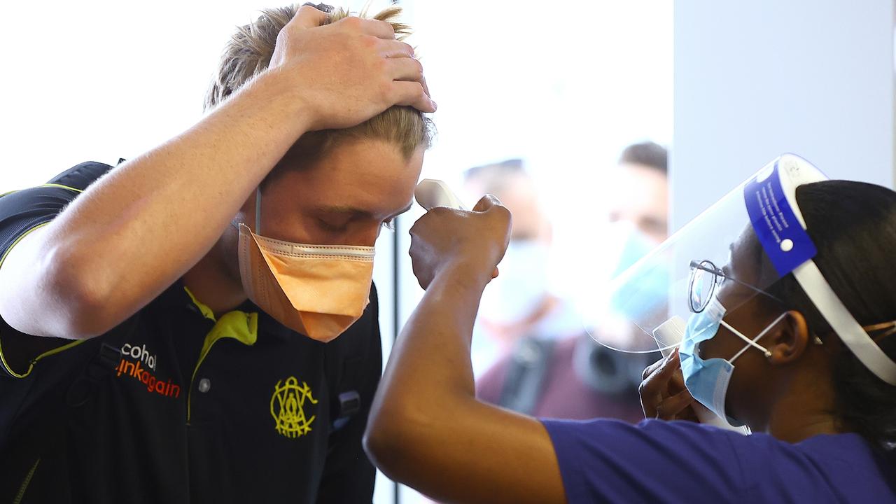 Cameron Green gets his temperature checked at Perth Airport.