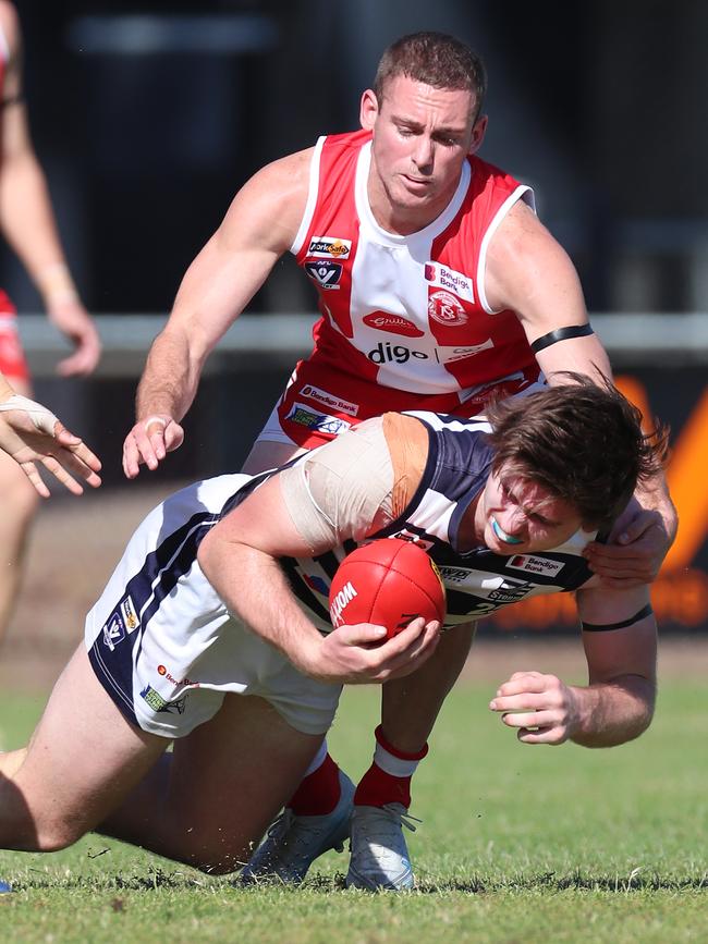 South Bendigo’s Brock Harvey closes in on Strathfieldsaye’s Timothy Hosking.
