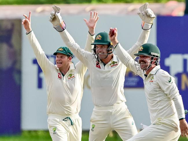 Australia's Travis Head (R) celebrates with teammates after taking the wicket of Sri Lanka's Angelo Mathews during the second day of the first Test cricket match between Sri Lanka and Australia at the Galle International Cricket Stadium in Galle on January 30, 2025. (Photo by Ishara S. KODIKARA / AFP)