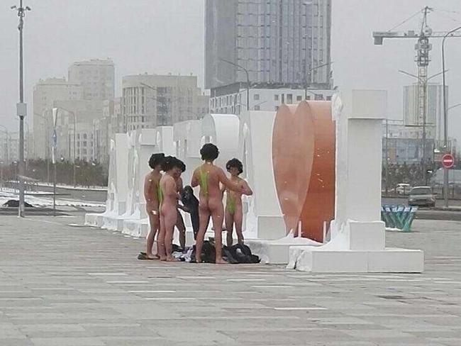 In this image made available by informburo.kz,  on Wednesday Nov. 15, 2017 shows a group of Czech tourists dressed in swimsuits made famous by TV and film character Borat in Atana,  Friday Nov. 10, 2017.  The group of six Czech tourists who visited Kazakhstan dressed up in  the skimpy swimsuits  have reportedly been detained by authorities in the central Asian country's capital Astana. Sporting lime green "mankinis" and black wigs, the men had hoped to take a picture in front of the "I Love Astana" sign. But local police detained them on Friday and fined them 22,500 tenge ($68) each, according to the Kazakh news website informburo.kz. (informburo.kz, via AP)