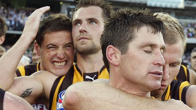 Trent Croad and Luke Hodge soak up Hawthorn's 2008 premiership win.